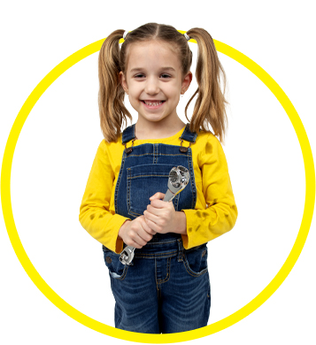 cute little girl pretending to be mechanic with grease stains on her shirt and overalls